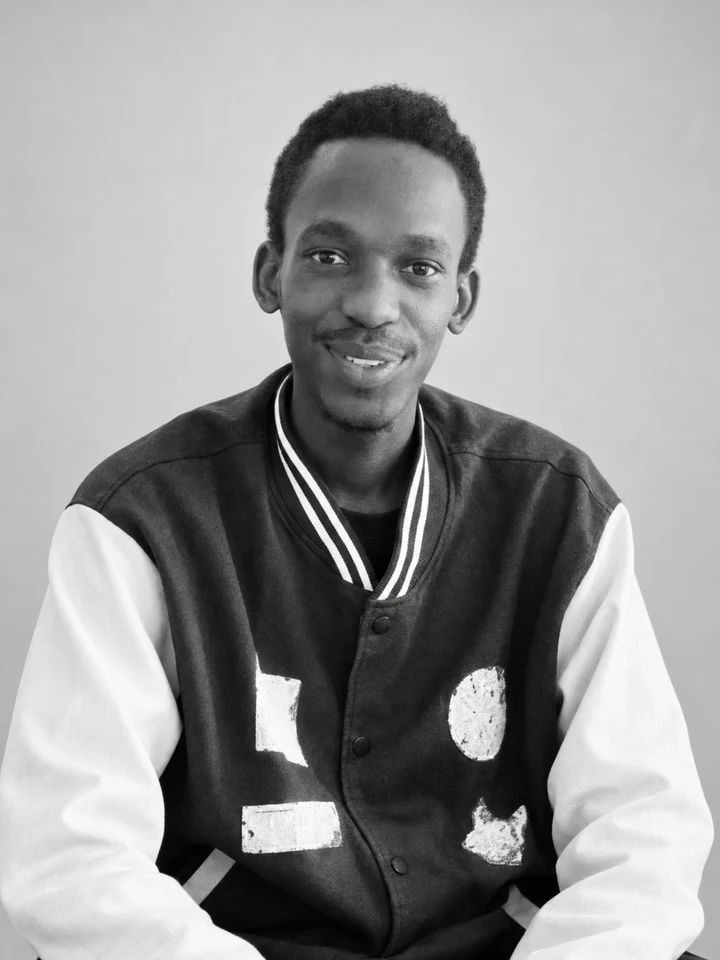 Desire in a varsity jacket, smiling
